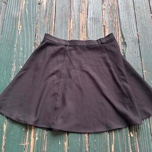 Black mini skirt with a touch of grunge charm